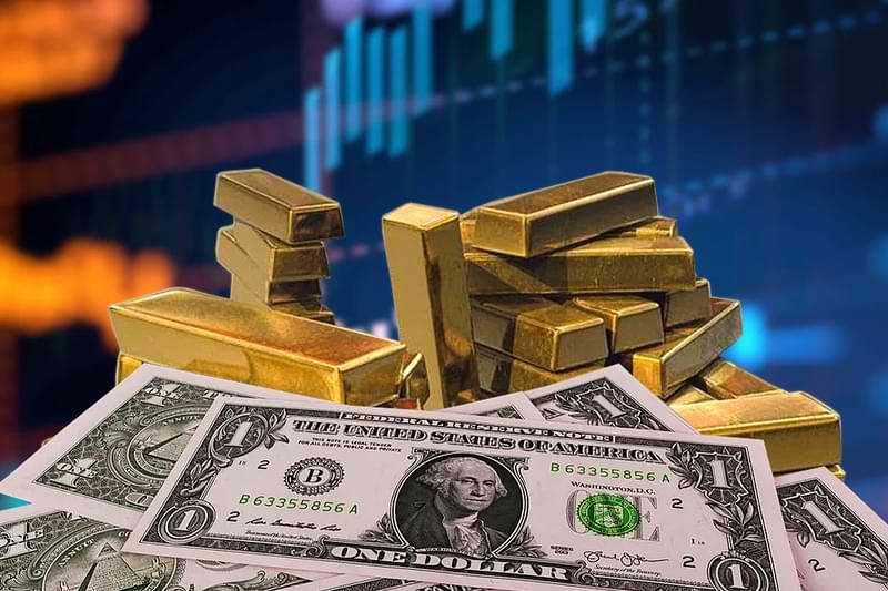 Image with a trading chart and gold bars behind a pile of cash showing 1 dollar bills.